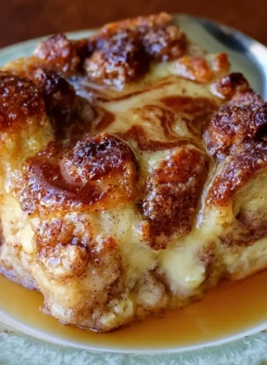 Delicious French Toast Casserole topped with syrup and berries