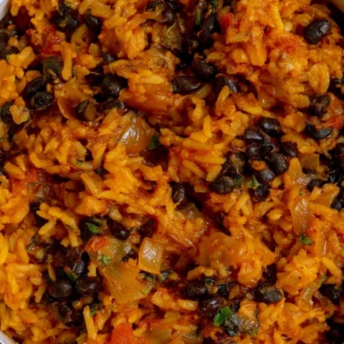 Delicious bowl of black beans and rice topped with fresh herbs