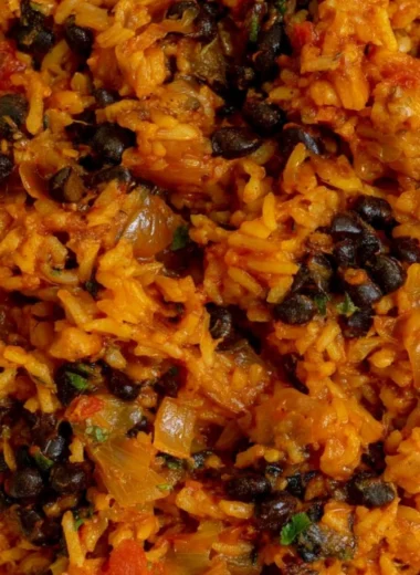 Delicious bowl of black beans and rice topped with fresh herbs