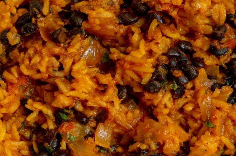 Delicious bowl of black beans and rice topped with fresh herbs
