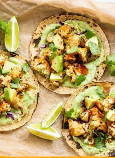 Delicious cauliflower tacos served with creamy avocado sauce.