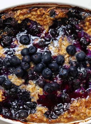 Cozy bowl of blueberry baked oatmeal topped with fresh blueberries