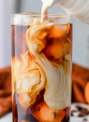 Cozy Pumpkin Spice Cold Brew with whipped cream and spice garnish