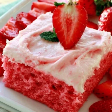 Cozy Strawberry Texas Sheet Cake topped with fresh strawberries and whipped cream
