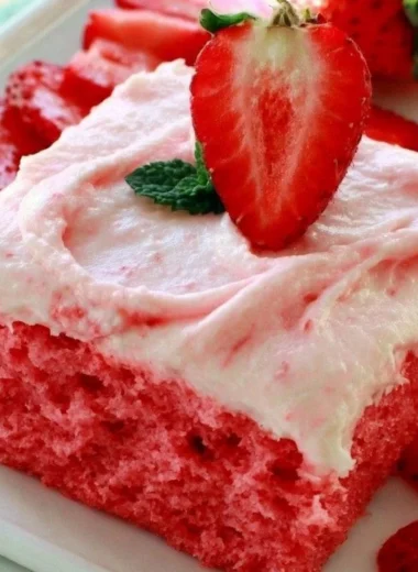 Cozy Strawberry Texas Sheet Cake topped with fresh strawberries and whipped cream