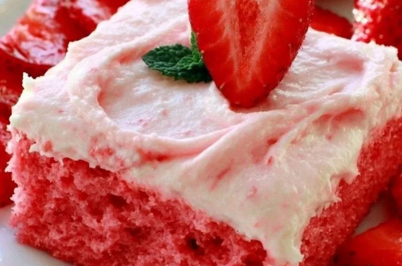 Cozy Strawberry Texas Sheet Cake topped with fresh strawberries and whipped cream