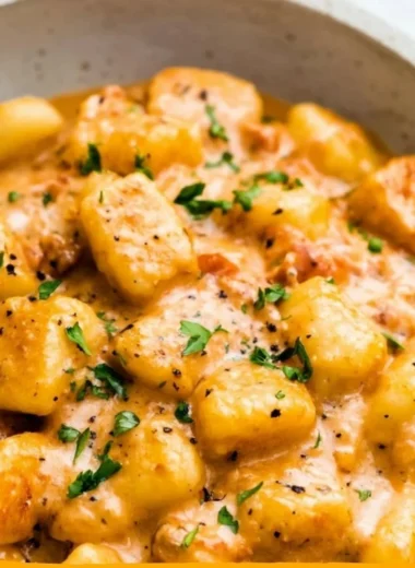 Delicious garlic butter gnocchi served in a bowl with herbs and cheese.