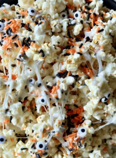 Colorful Halloween popcorn in spooky themed bowls for festive snacking