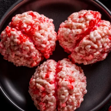 Colorful Halloween Rice Krispies Treats shaped like ghosts and pumpkins.