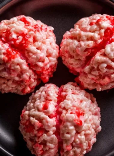 Colorful Halloween Rice Krispies Treats shaped like ghosts and pumpkins.