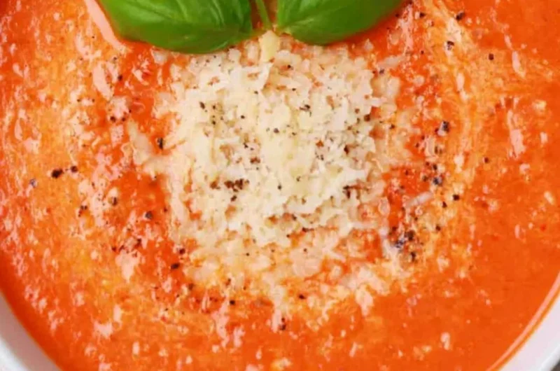 Delicious high protein tomato soup served in a bowl with fresh herbs