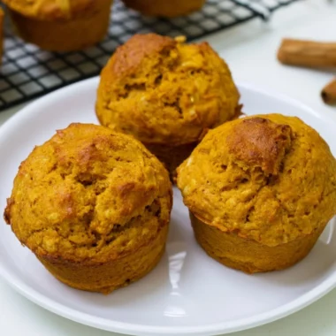 Freshly baked pumpkin oatmeal muffins with a sprinkle of oats and spices