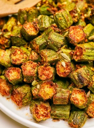 Delicious roasted okra served on a plate, showcasing its vibrant color and texture.