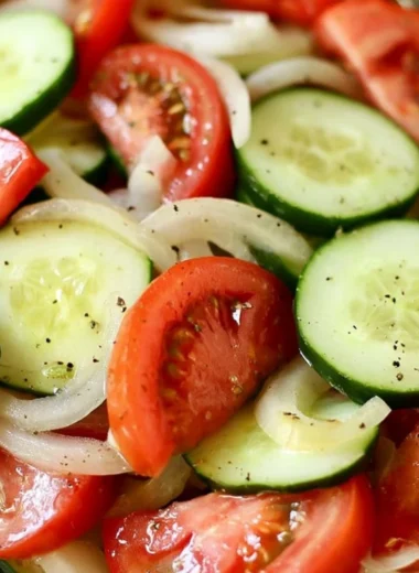 Fresh tomato, cucumber, and onion salad served in a bowl.