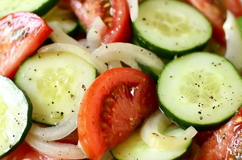 Fresh tomato, cucumber, and onion salad served in a bowl.