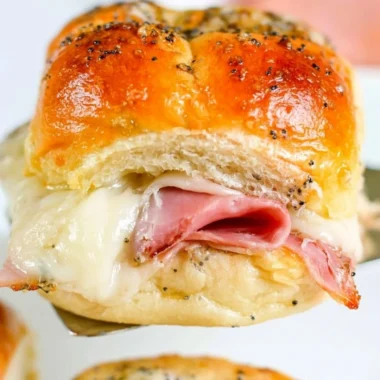 Baked ham and cheese sliders served on a platter