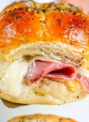 Baked ham and cheese sliders served on a platter