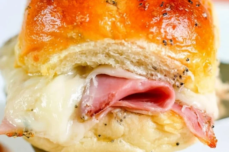 Baked ham and cheese sliders served on a platter