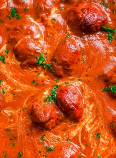 Delicious bowl of chicken tikka masala served with rice and naan bread