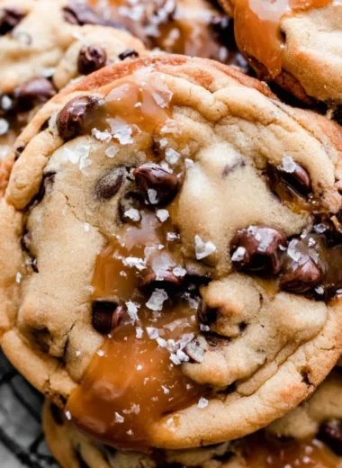 Freshly baked salted caramel chocolate chip cookies on a cooling rack