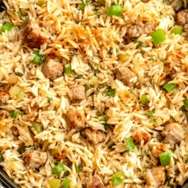 Plate of Cajun dirty rice with sausage garnished with green onions