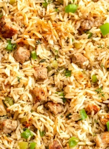 Plate of Cajun dirty rice with sausage garnished with green onions