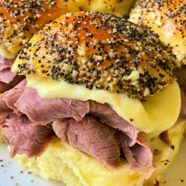 Cozy roast beef sliders served on a rustic wooden platter