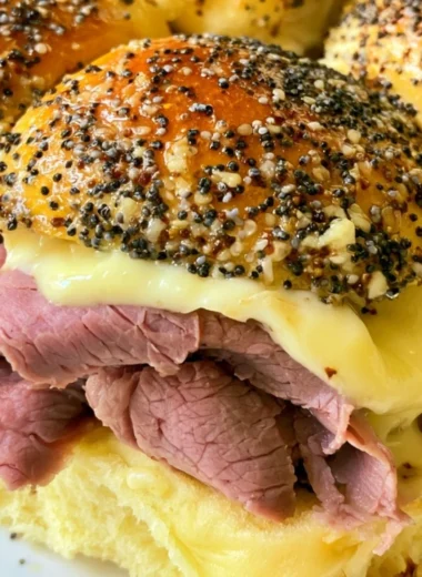Cozy roast beef sliders served on a rustic wooden platter