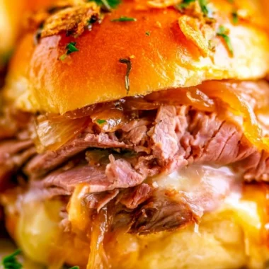 French Dip Sliders with beef and dipping sauce served on a platter