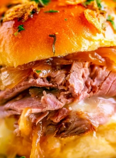 French Dip Sliders with beef and dipping sauce served on a platter