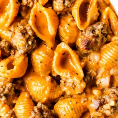 Bowl of Homemade Hamburger Helper topped with cheese and parsley