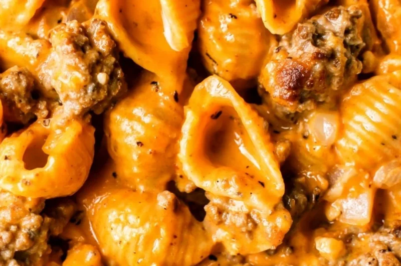 Bowl of Homemade Hamburger Helper topped with cheese and parsley