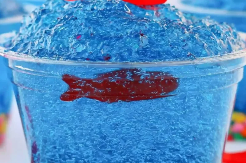 Mini fish tank Jell-O cups with colorful gummy fish and seaweed decorations.