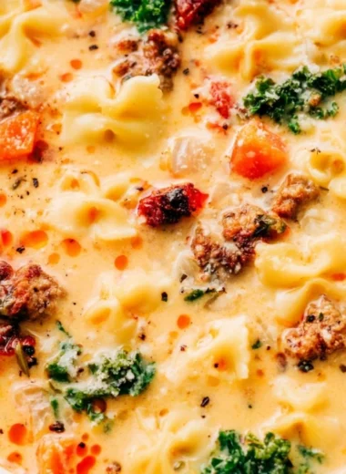 Delicious bowl of warm Italian sausage pasta soup served with fresh herbs.