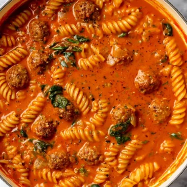 Bowl of creamy Italian meatball soup with fresh herbs and vegetables