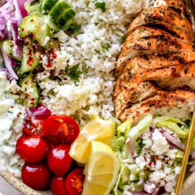 Greek chicken bowls with fresh vegetables and herbs