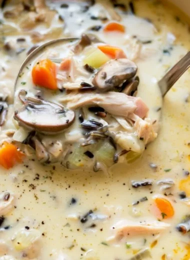 Bowl of leftover turkey wild rice soup garnished with herbs