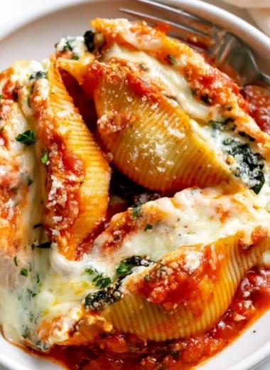 Delicious stuffed shells topped with marinara sauce and cheese