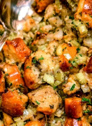 Bowl of traditional Thanksgiving stuffing with herbs and vegetables ready to serve