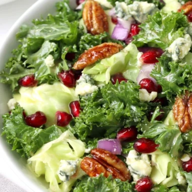 Winter chopped salad featuring pomegranate seeds and blue cheese on a festive table.
