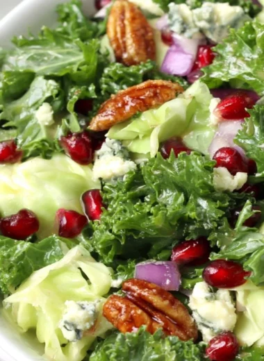 Winter chopped salad featuring pomegranate seeds and blue cheese on a festive table.